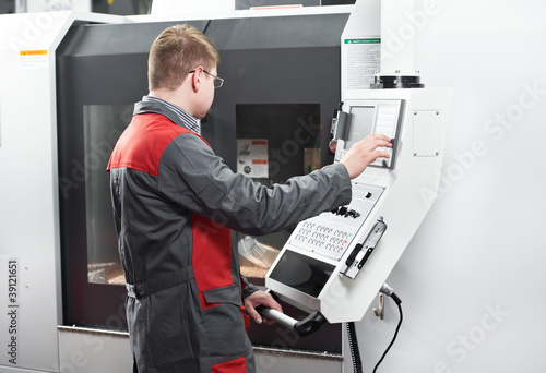 Photo: laborer working with machine tool laborer working with machine tool