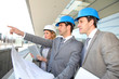 Construction engineers checking building site
