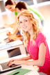 Beautiful blond girl working on laptop computer