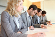 Young business people signing application form