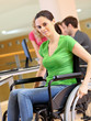 Young woman in wheelchair working in office