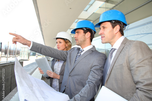 Photo: Construction engineers checking building site Construction engineers checking building site