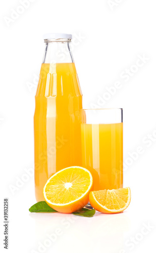 Photo: Orange juice glass bottle and oranges. Orange juice glass bottle and oranges.