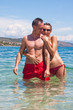 Handsome couple hugging in water