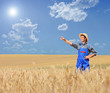 Photo: Young farmer pointing in a wheat field Young farmer pointing in a wheat field