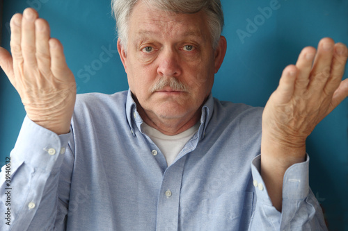 Photo: older man shrugs with his hands up older man shrugs with his hands up