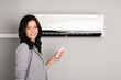 girl with a remote control air conditioner