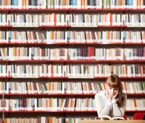 Photo: Young student in a library Young student in a library