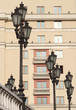 Many retro styled lanterns in front of beige building