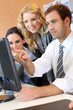 Business meeting in front of desktop computer