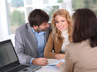 Couple signing property contract Couple signing property contract