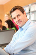 Man sitting in office in front of laptop computer