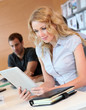 Beautiful office worker using tablet in office