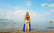 The girl on seacoast looks in a distance The girl on seacoast looks in a distance