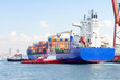 Container ship and tug boats
