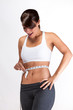 Photo: Pretty woman happy measuring waist Pretty woman happy measuring waist
