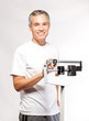 Photo: handsome happy man on scale handsome happy man on scale