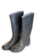 dirty rubber boots isolated on white