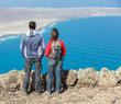 Sport couple standing on cliff's edge