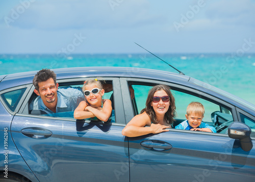 Photo: A family of four driving in a car A family of four driving in a car