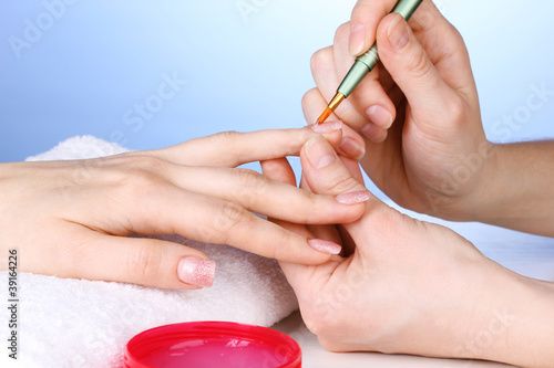 Photo: Manicure process in salon Manicure process in salon