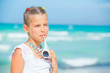 Adorable happy smiling girl on beach vacation