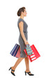 Woman in dress walking with shopping bags