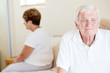 unhappy senior couple sitting on bed