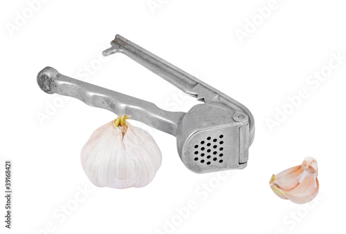 Photo: Garlic press and garlic, isolated on white background Garlic press and garlic, isolated on white background