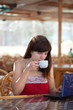 woman using laptop at cafe woman using laptop at cafe