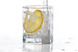 Glass of water, ice and slice of fresh lemon with splash