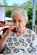 senior woman drinking a glass of tea senior woman drinking a glass of tea