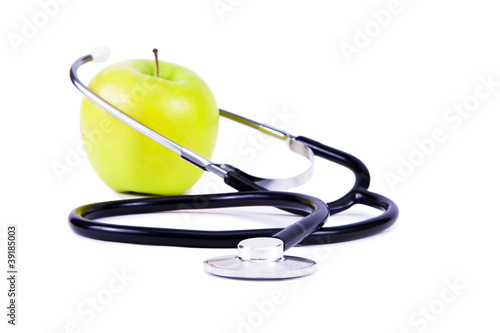 Photo: Green, ripe apple and stethoscope. Green, ripe apple and stethoscope.