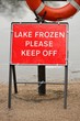 Bright red "Lake Frozen Please Keep Off" warning sign