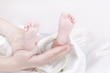 mother holding up baby`s feet