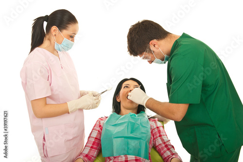 Photo: Dentist and nurse working with patient Dentist and nurse working with patient