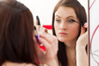 Beautiful brunette girl with mascara making her eyelash