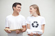 Couple holding piles of paper