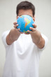 Photo: Young man holding a globe Young man holding a globe