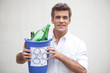 Photo: Man holding a trash bin with glass bottles Man holding a trash bin with glass bottles