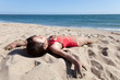 Little Girl Relaxing on the Beach Covered in Sand