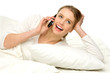 Young female in bed with a mobile phone
