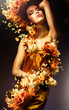 sensual woman in long yellow dress and flowers