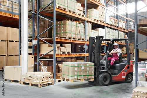 Photo: worker driver at warehouse forklift loader works worker driver at warehouse forklift loader works
