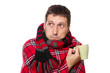 colds man wrapped in a warm blanket and scarf, holding a mug
