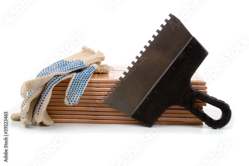 Photo: Ceramic tiles and trowel for repairs Ceramic tiles and trowel for repairs