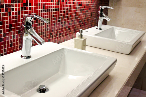 Photo: sinks and taps in a public toilet sinks and taps in a public toilet