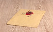 Envelope with sealing wax on wooden background