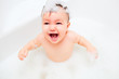 Happy litlle child bathes in a bathroom
