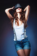sexy beautiful woman in hat and shorts with suspenders